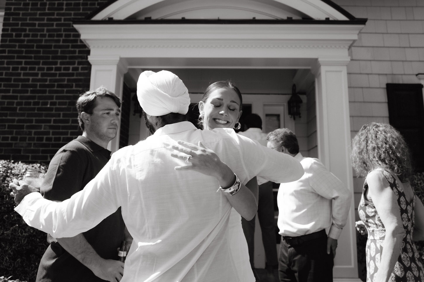 Black and white photojournalistic image of the would-be bride and groom welcoming their guests in their wedding shower, captured by Jenny Fu Studio.