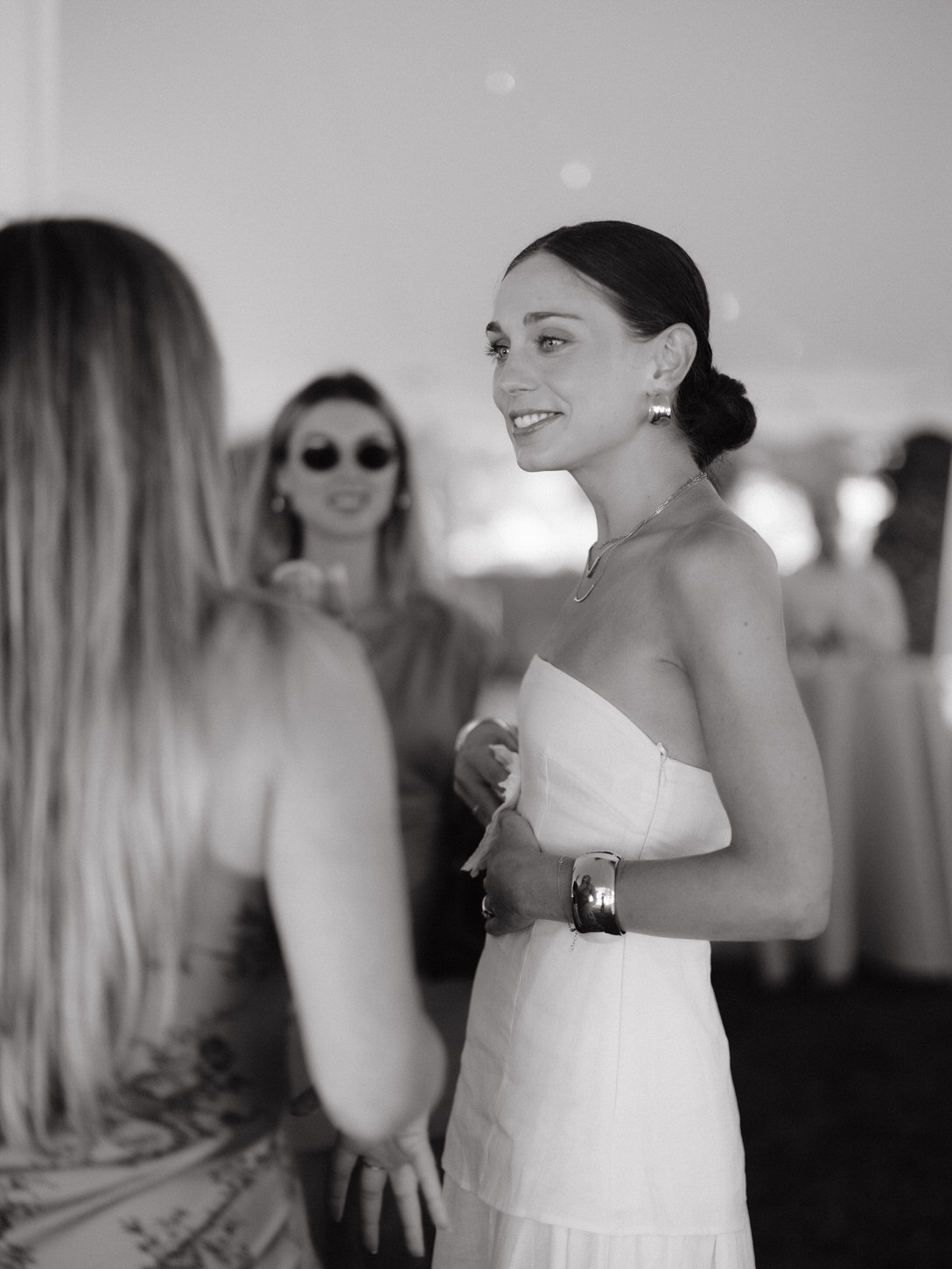 Black and white image of the would-be bride chatting with guests candidly captured for a wedding shower photo shoot by Jenny Fu Studio.