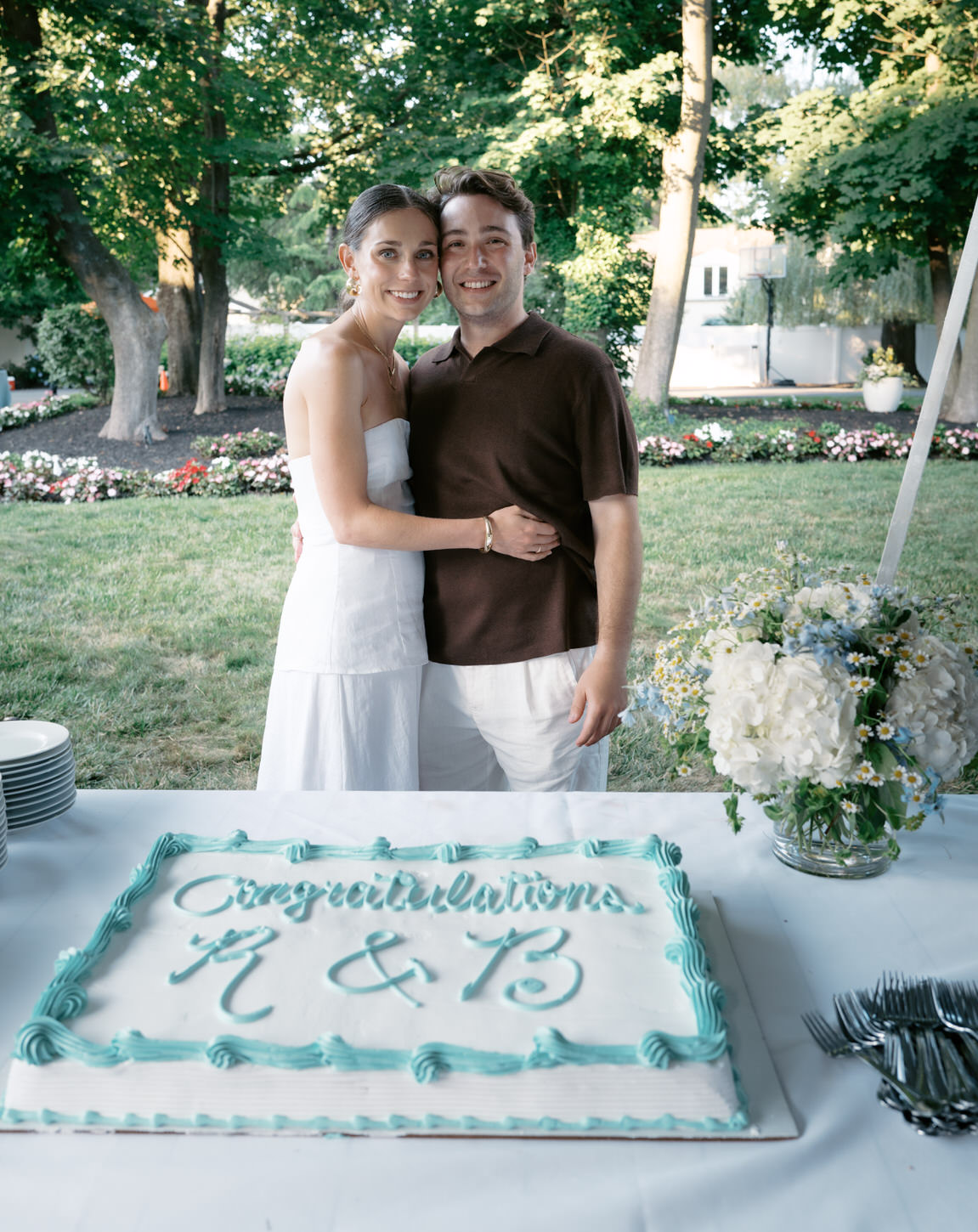 The would-be bride and groom pose with their cake in their wedding shower captured by Jenny Fu Studio.