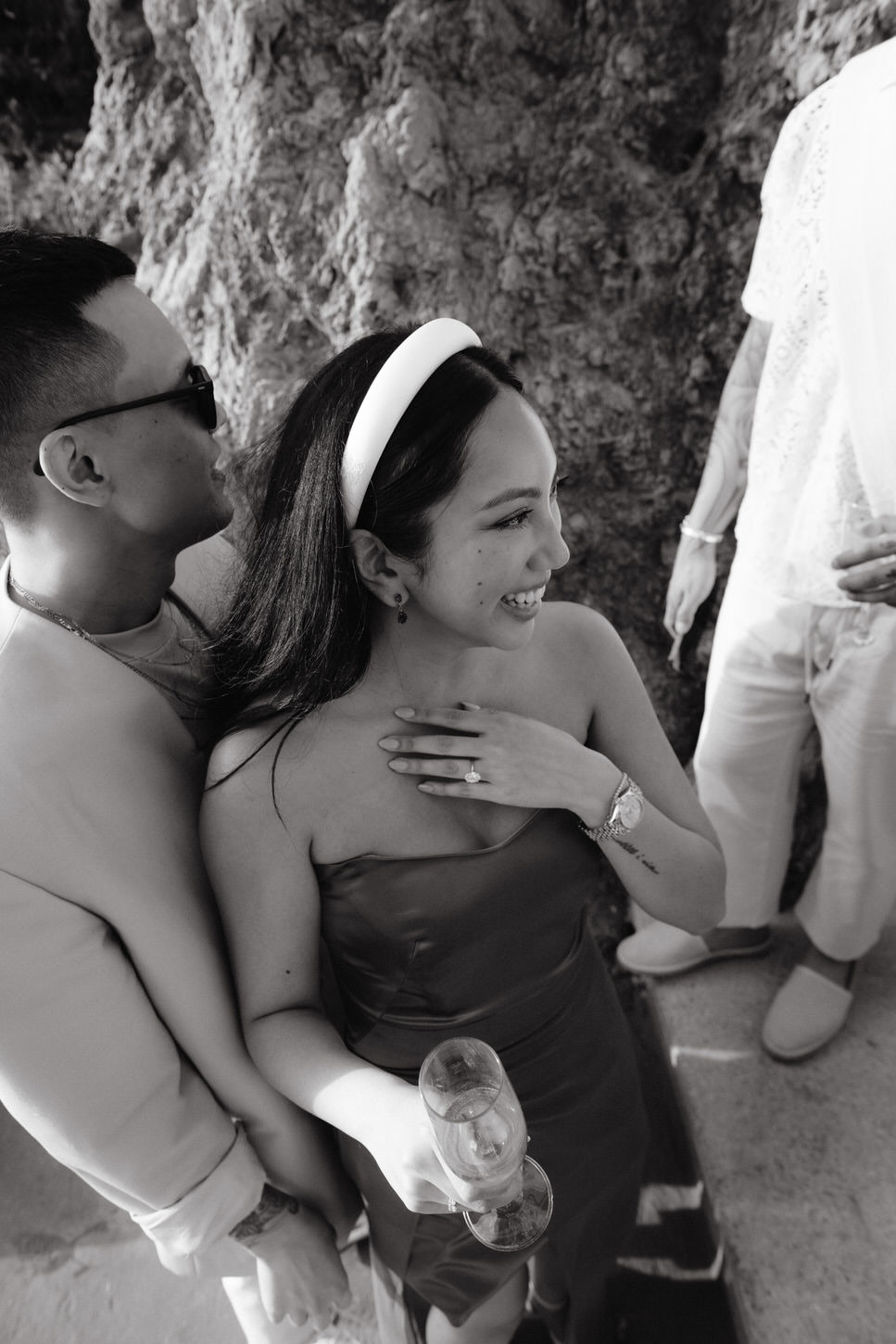 Black and white image of the would-be bride and groom enjoying their welcome dinner, captured by Jenny Fu Studio.