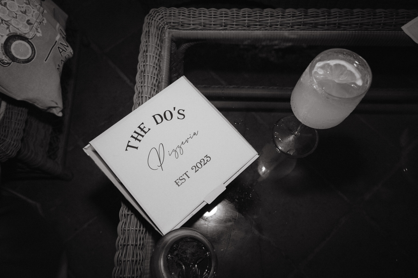 A black and white image of a table at The Do's Pizzeria in Italy, captured by Jenny Fu Studio for a pre-wedding event.