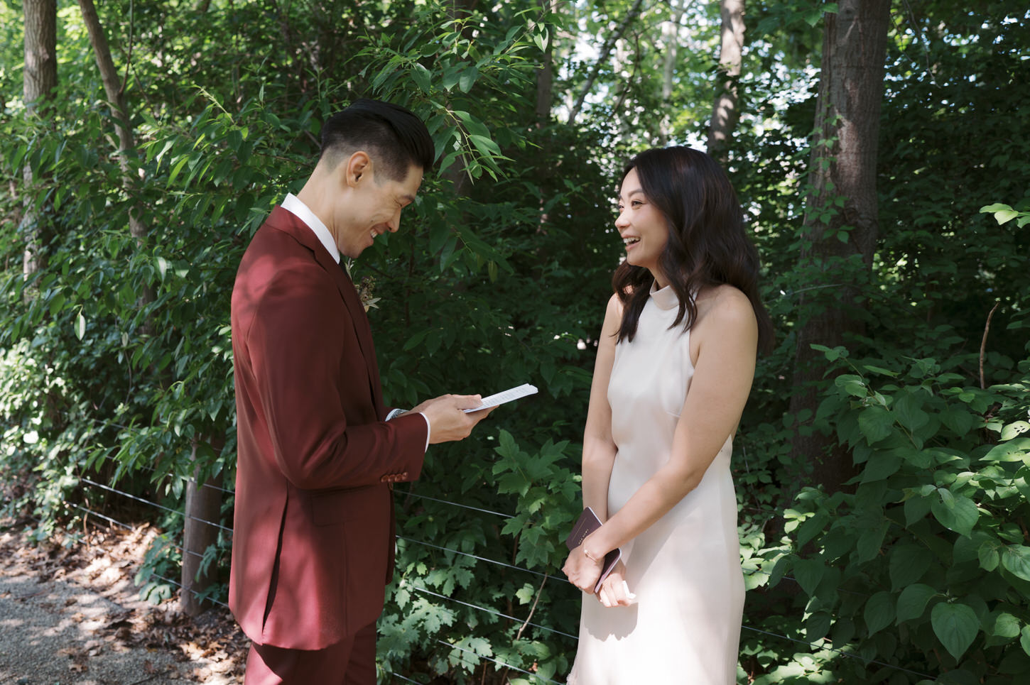 Candid image of an intimate moment of the groom reading a letter from his bride, captured by Jenny Fu Studio.