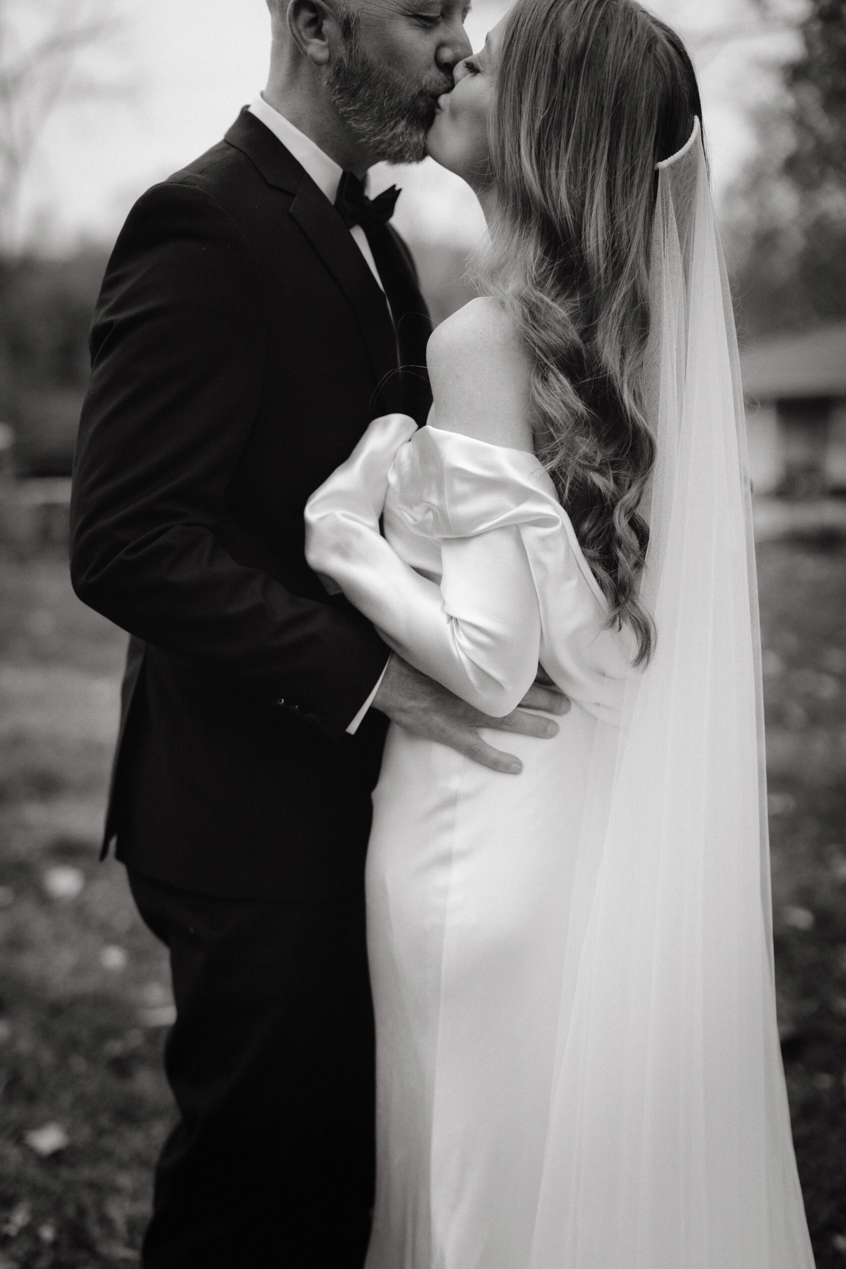 The bride and groom are kissing after the wedding ceremony captured by Jenny Fu Studio.