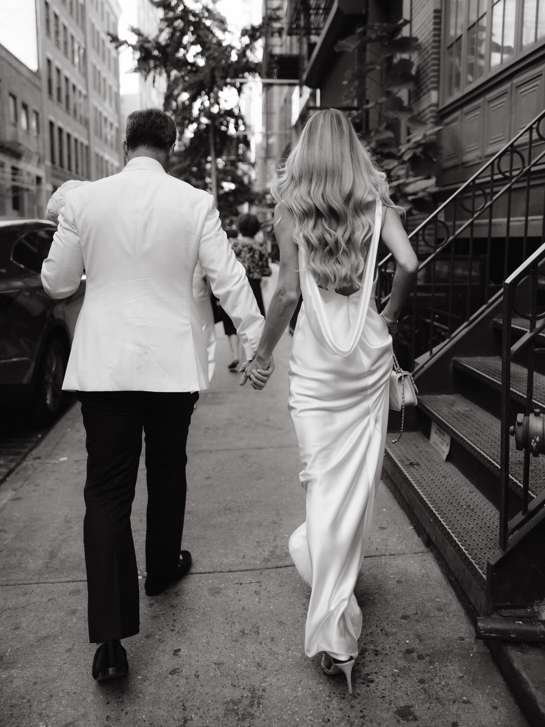 The newlyweds are walking in the streets of Manhattan, captured by Jenny Fu Studio.