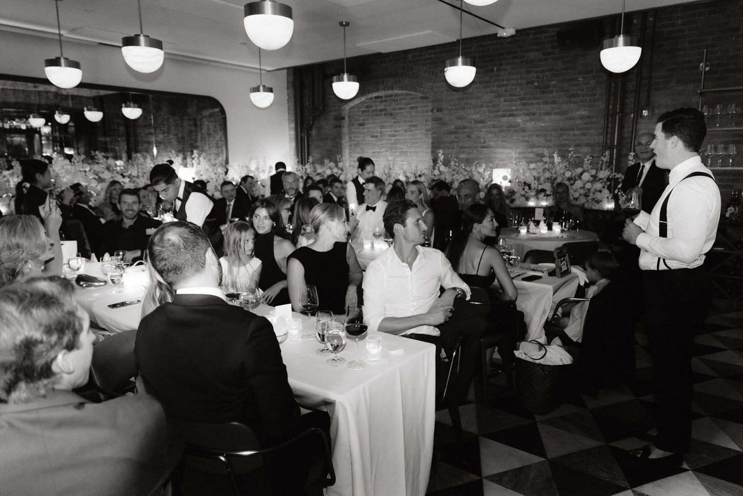 Black and white photo of the guests in the NYC wedding reception, captured by Jenny Fu Studio. 