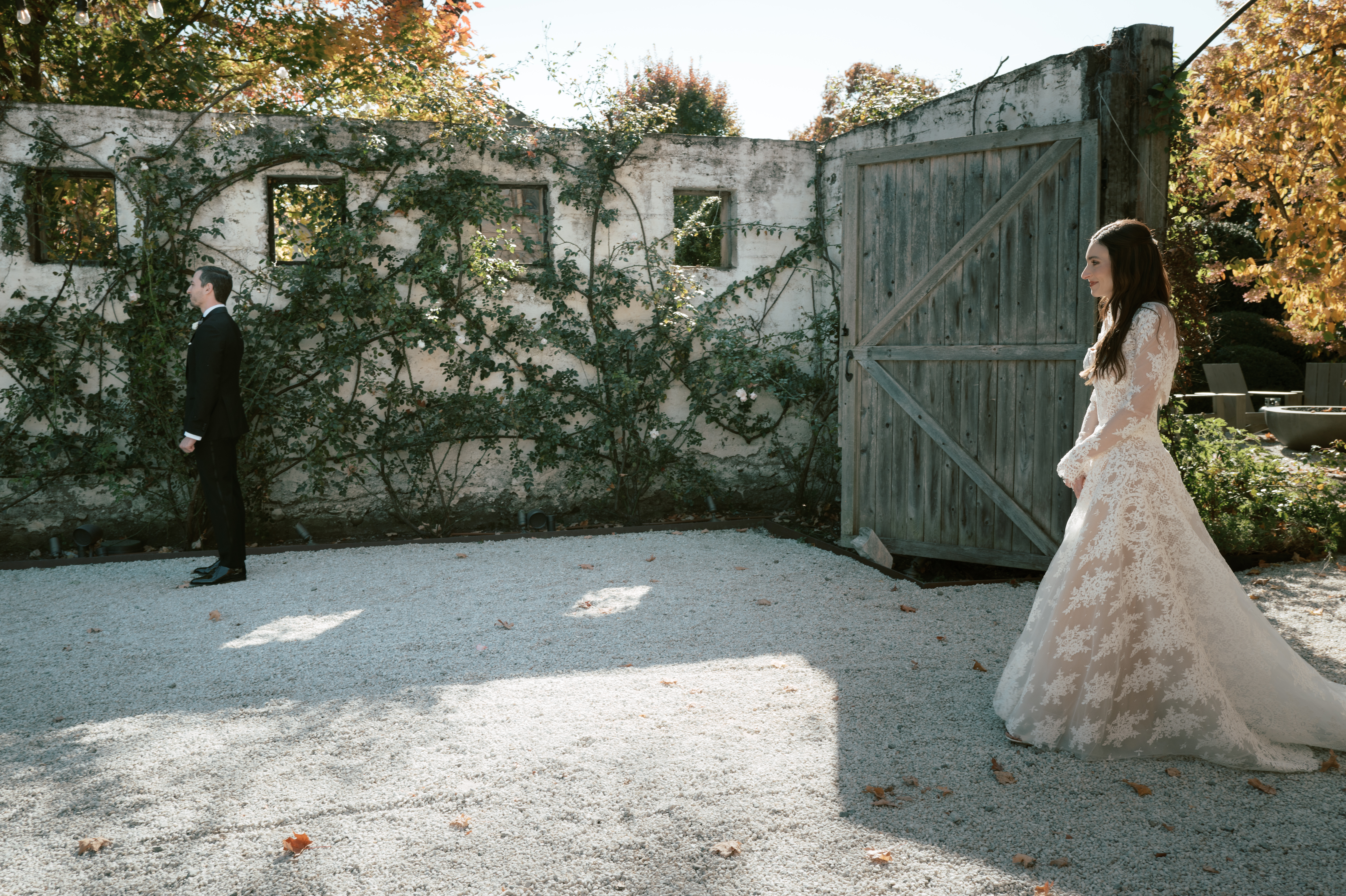 First look image of the bride and groom in a garden in Upstate New York, captured in hybrid wedding photography by Jenny Fu Studio