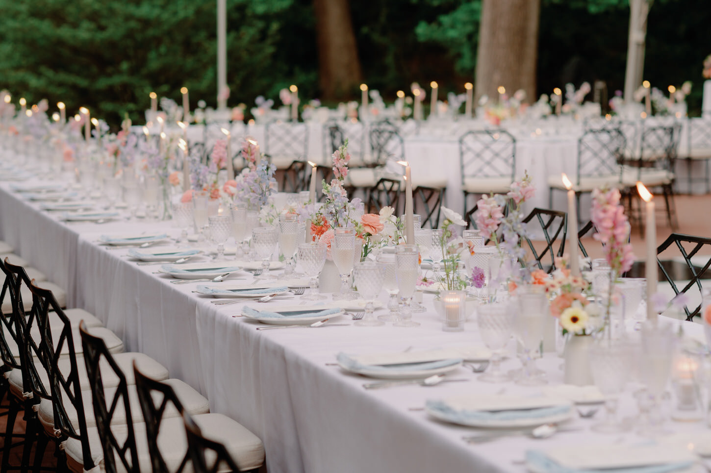 A beautiful wedding reception set-up with candles and pretty flower centerpieces, captured in an elegant wedding portrait by Jenny Fu Studio.