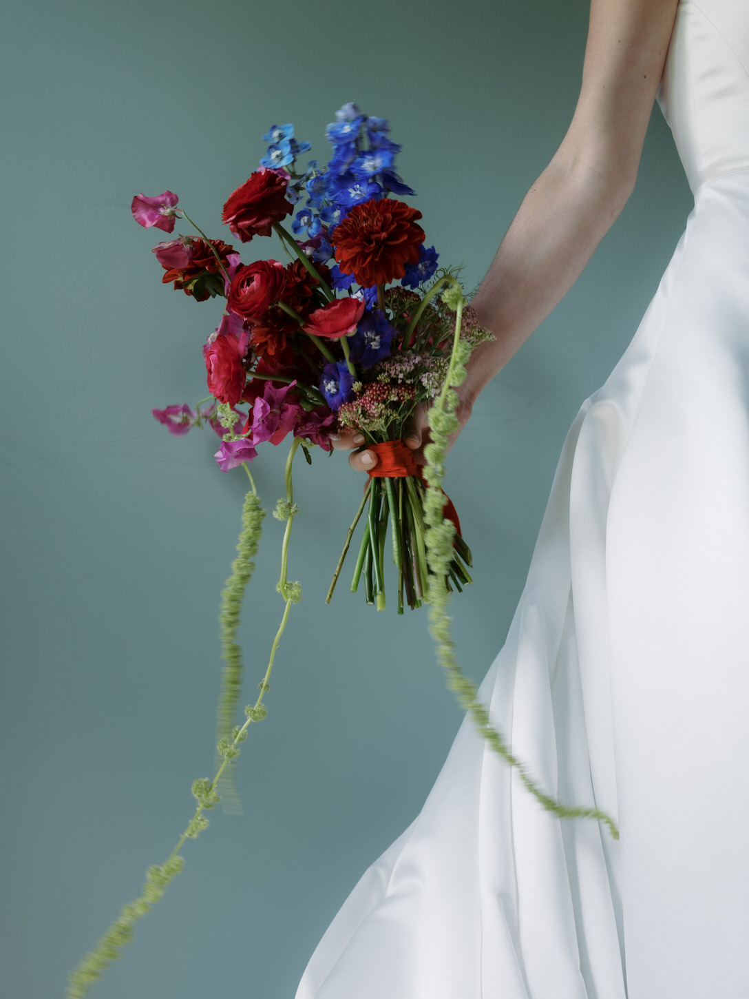 A timeless image of a colorful wedding bouquet held by the bride, captured by Jenny Fu Studio.