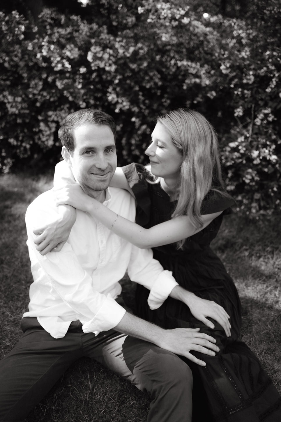 Black and white photo of the engaged couple having an intimate moment at Central Park, NYC, captured by Jenny Fu Studio.