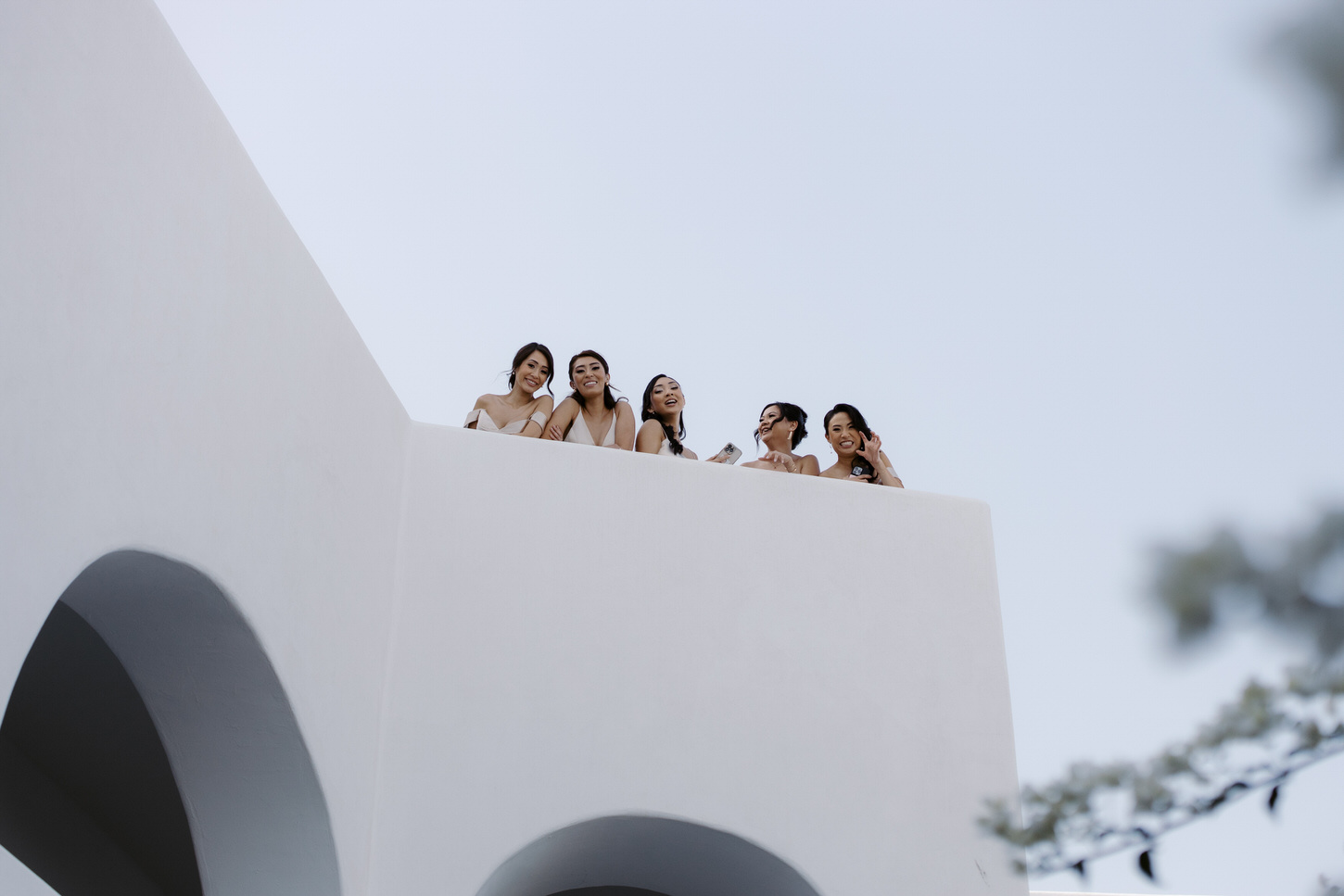 Getting-ready photo of the bridesmaids outdoors, in a destination wedding photo captured by Jenny Fu Studio.