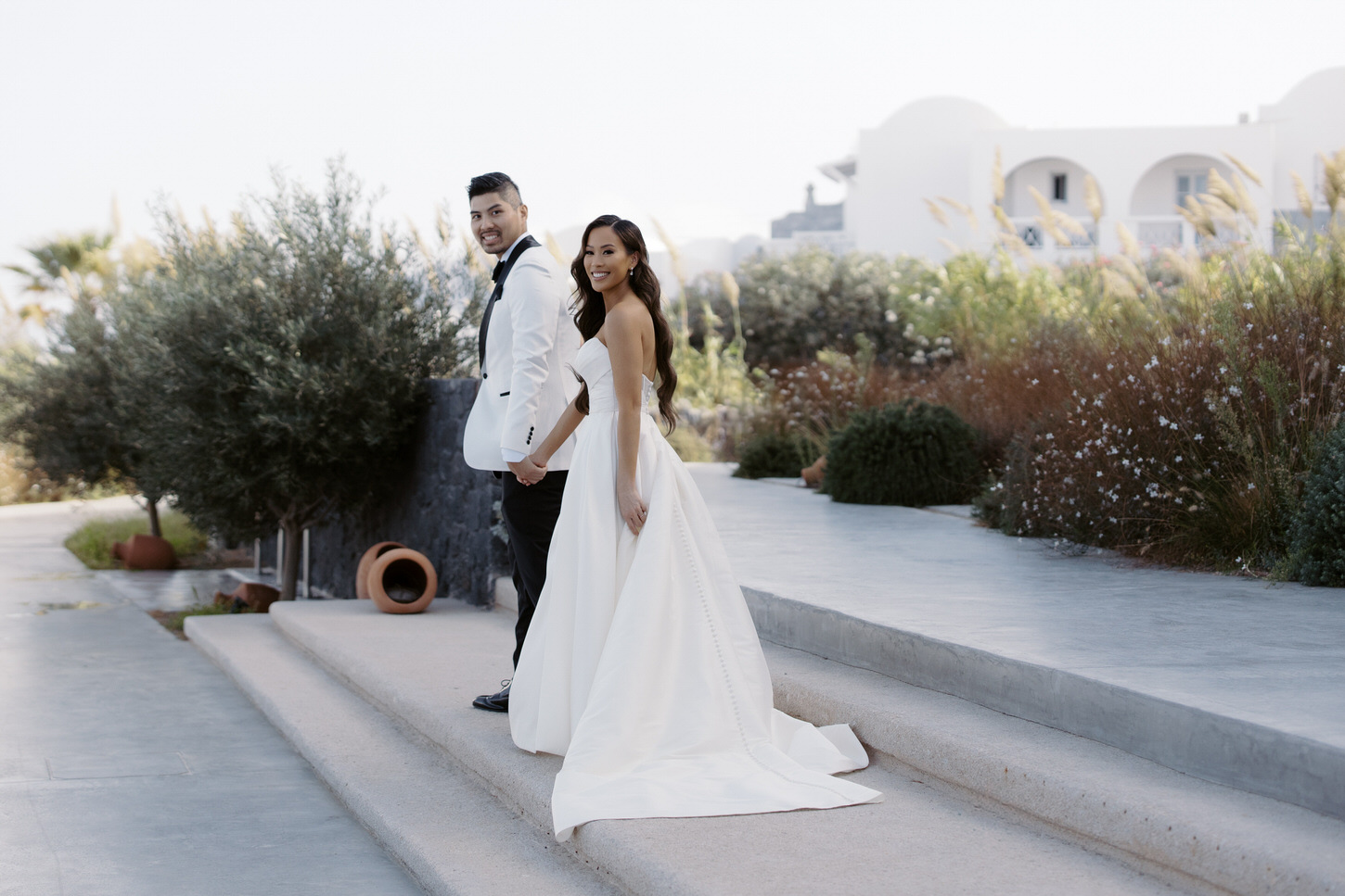 Lovely portrait of the bride and groom outdoors in Greece captured by destination wedding photographer, Jenny Fu Studio.