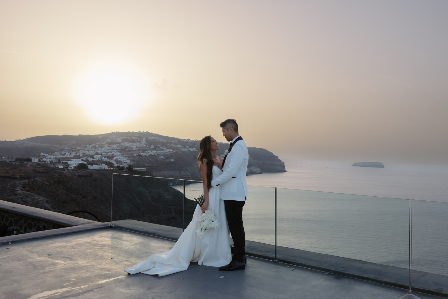 A golden hour image of the newlyweds in Greece, captured by destination wedding photographer, Jenny Fu Studio.