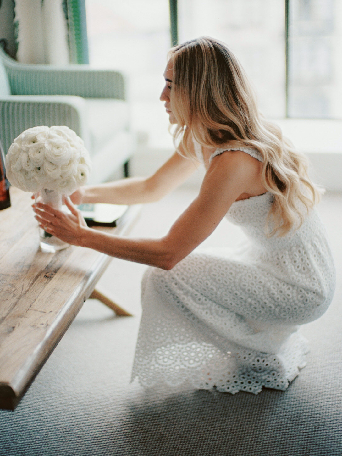 The bride is preparing her bouquet as she gets ready for the wedding ceremony, captured by Jenny Fu Studio.