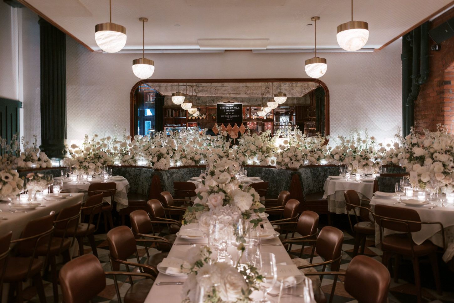 An elegant wedding reception setup overflowing with beautiful white flowers in a dreamlike wedding photo image captured by Jenny Fu Studio.