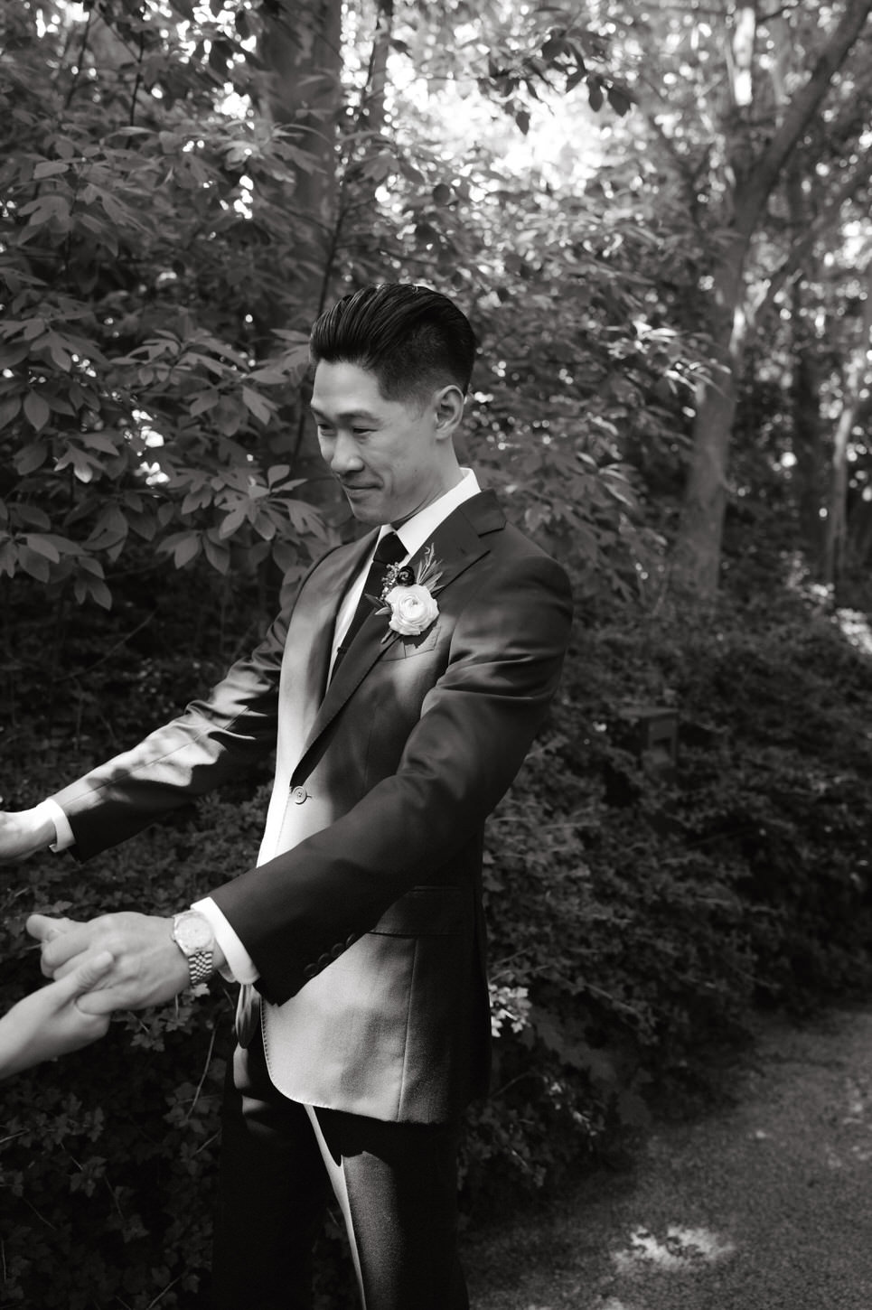 Black and white image of the groom's reaction during first look, a cinematic wedding storytelling image by Jenny Fu Studio.
