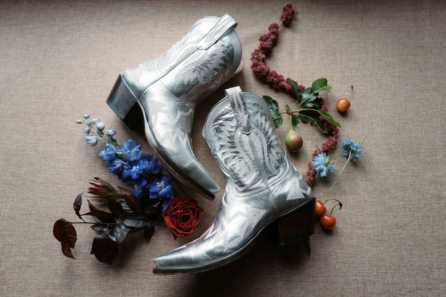 Silver boots with wild flowers in an Upstate New York wedding, an iconic wedding photography captured by Jenny Fu Studio.