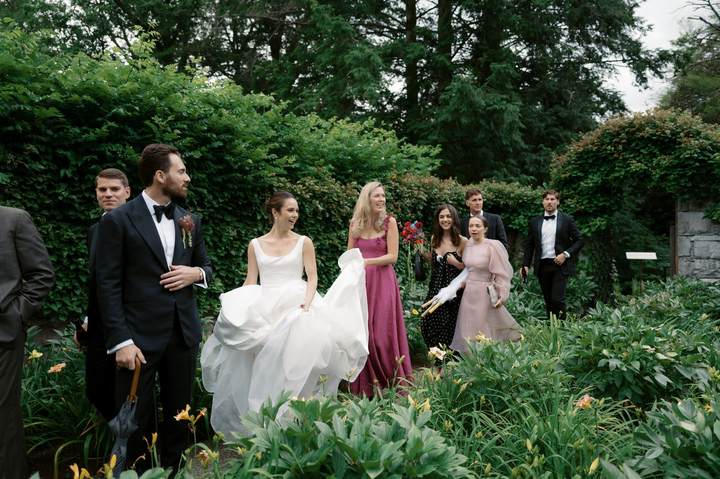 A candid shot of the bride, groom, bridesmaids and groomsmen while going to the ceremony, an iconic wedding photography captured by Jenny Fu Studio.