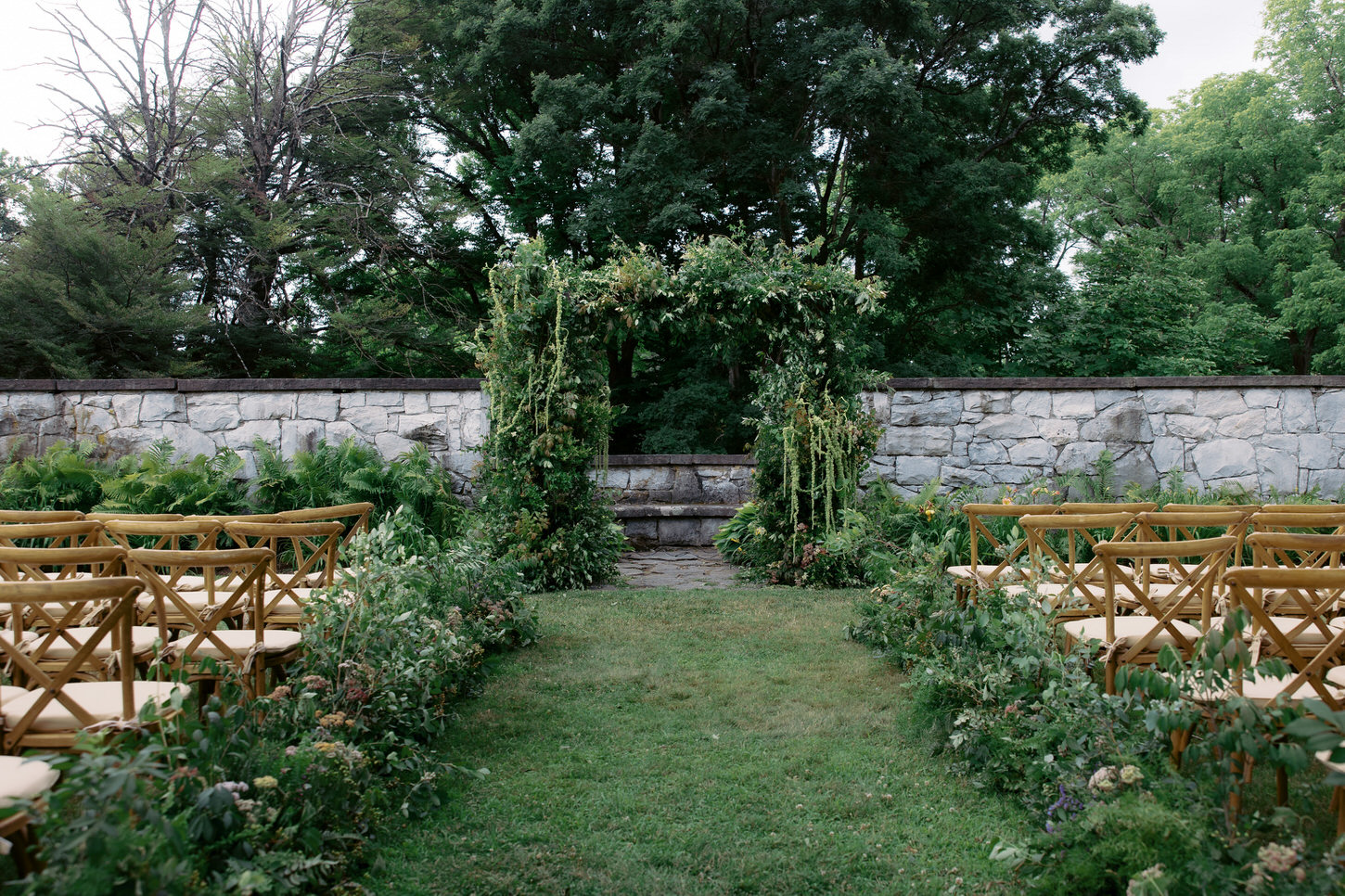 A beautiful outdoor wedding ceremony set-up with lots of greens in Upstate New York, an iconic wedding photography captured by Jenny Fu Studio.