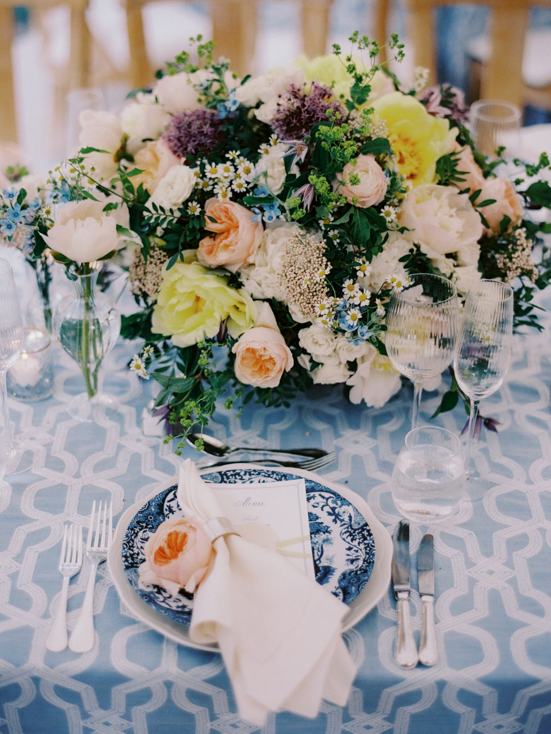 Colorful bunch of flowers as dining table centerpiece in a wedding reception captured by Jenny Fu Studio.