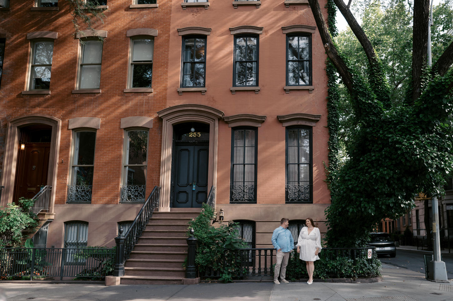 The engaged couple are chatting in the streets of West Village, NYC, captured by Jenny Fu Studio.