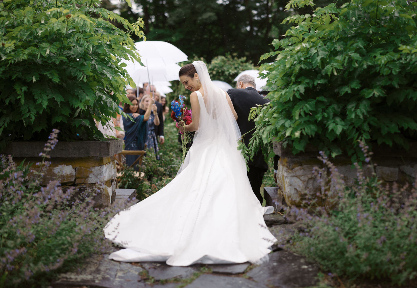 The bride is walking towards the aisle with her father, captured by high-fashion wedding photographer, Jenny fu Studio.