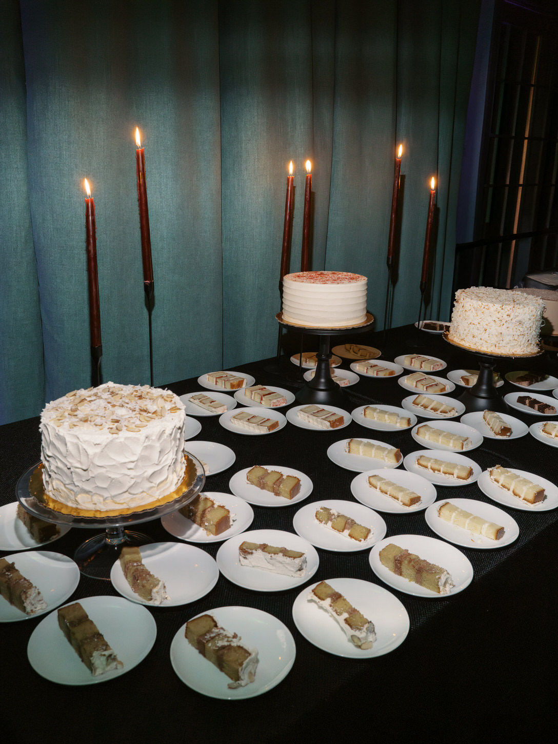 White wedding cakes and cake slices ready to be served for the guests, captured by high-fashion wedding photographer, Jenny fu Studio.