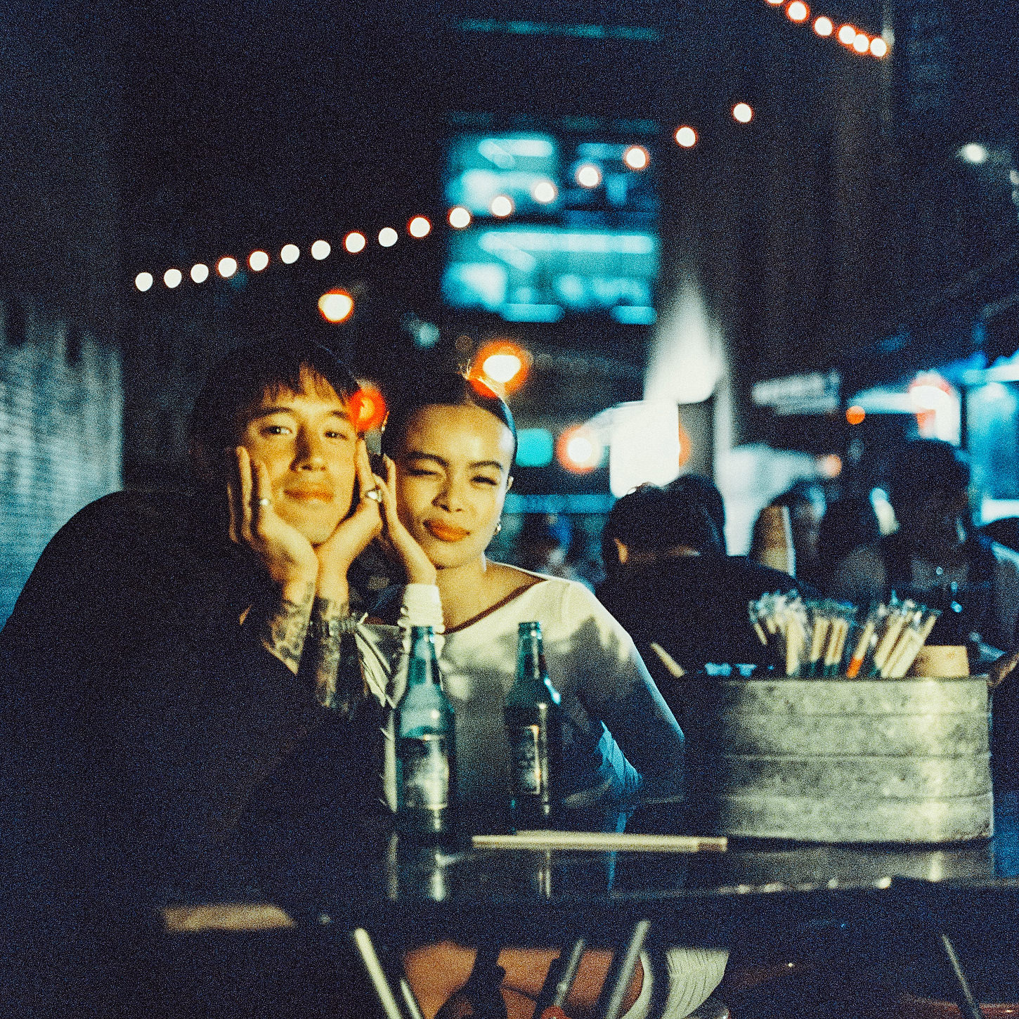 Couple enjoying noodles at a Chinatown night market during their cinematic NYC elopement.