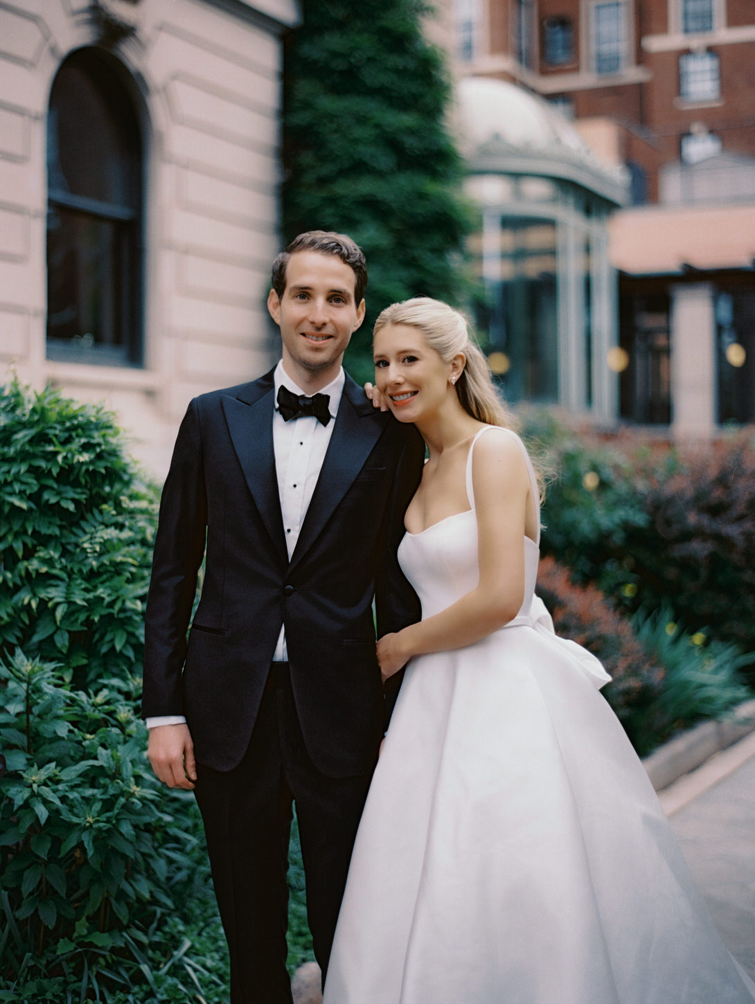 Portrait of the bride and groom with a garden background, a documentary wedding photo captured by Jenny Fu Studio NYC.