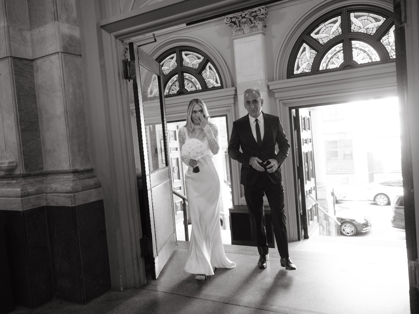 The bride is emotional as she walks towards the aisle with her father, captured by Jenny Fu Studio, a High-fashion wedding photographer in NYC. 