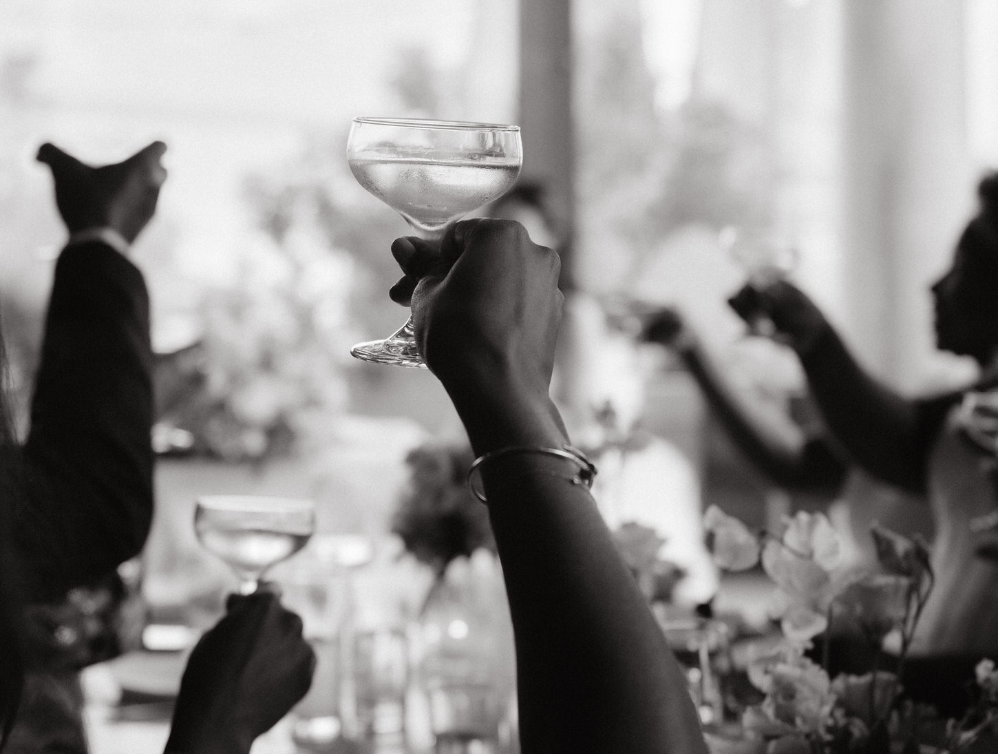Black and white photojournalistic image of the toast in a wedding reception in NYC, captured by Jenny Fu Studio.