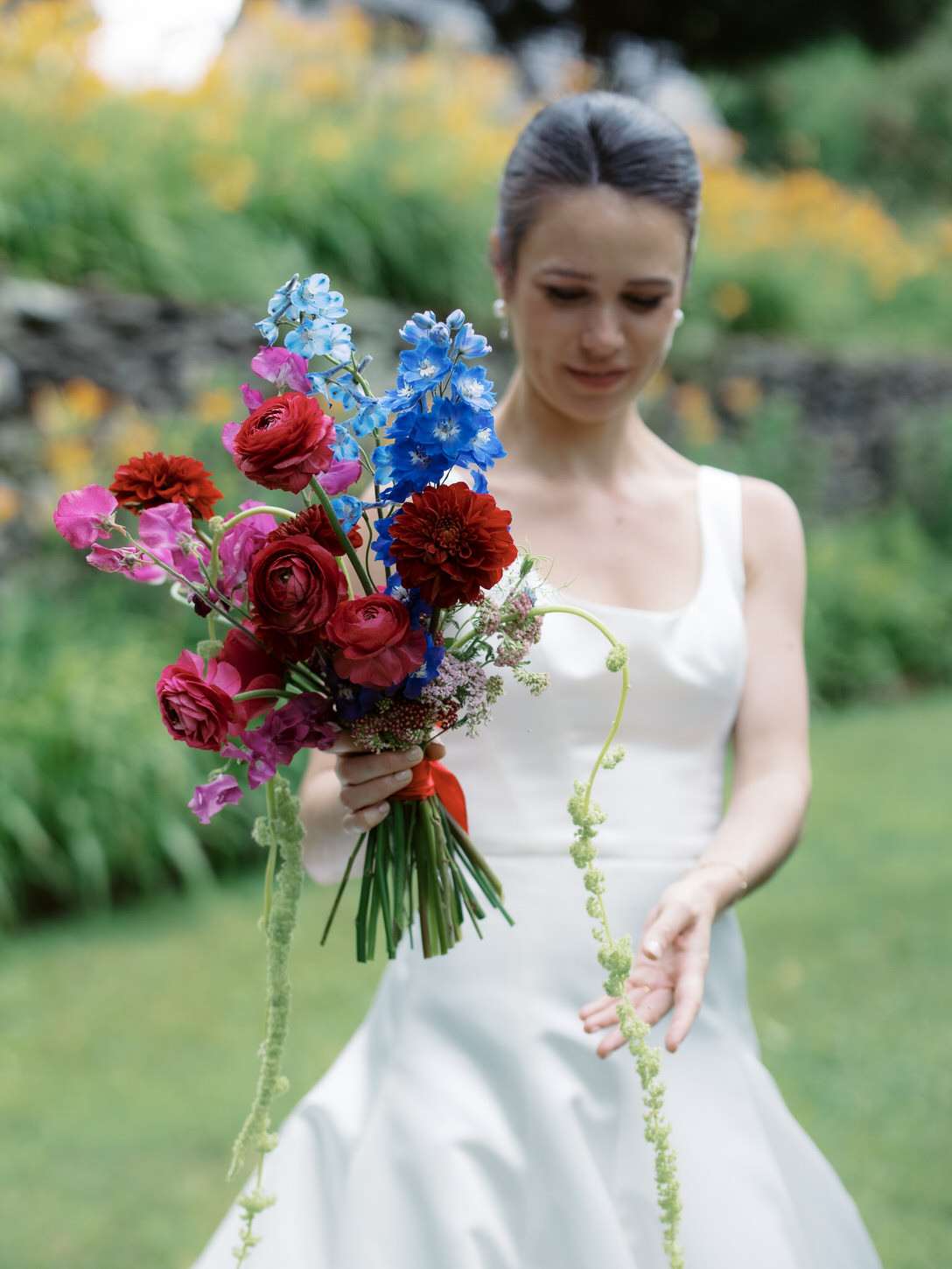 The bride holding colorful flowers captured by high-fashion wedding photographer, Jenny Fu Studio.